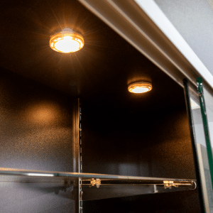 Black 78-inch wall case display with glass sliding doors, push lock, five adjustable 12-inch shelves, LED down-lights, and a matching back panel.