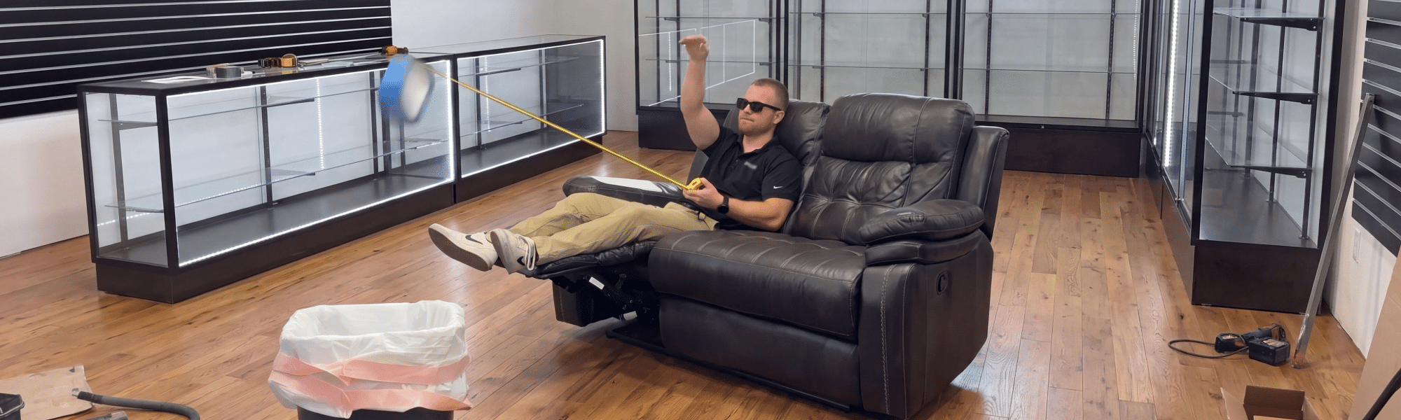 DISPLAYARAMA team member tossing away blue floor tape in a retail store